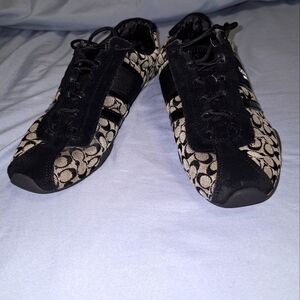 A pair of Coach sneakers in a ladies size 7.5B. Pre-loved with some flaws
